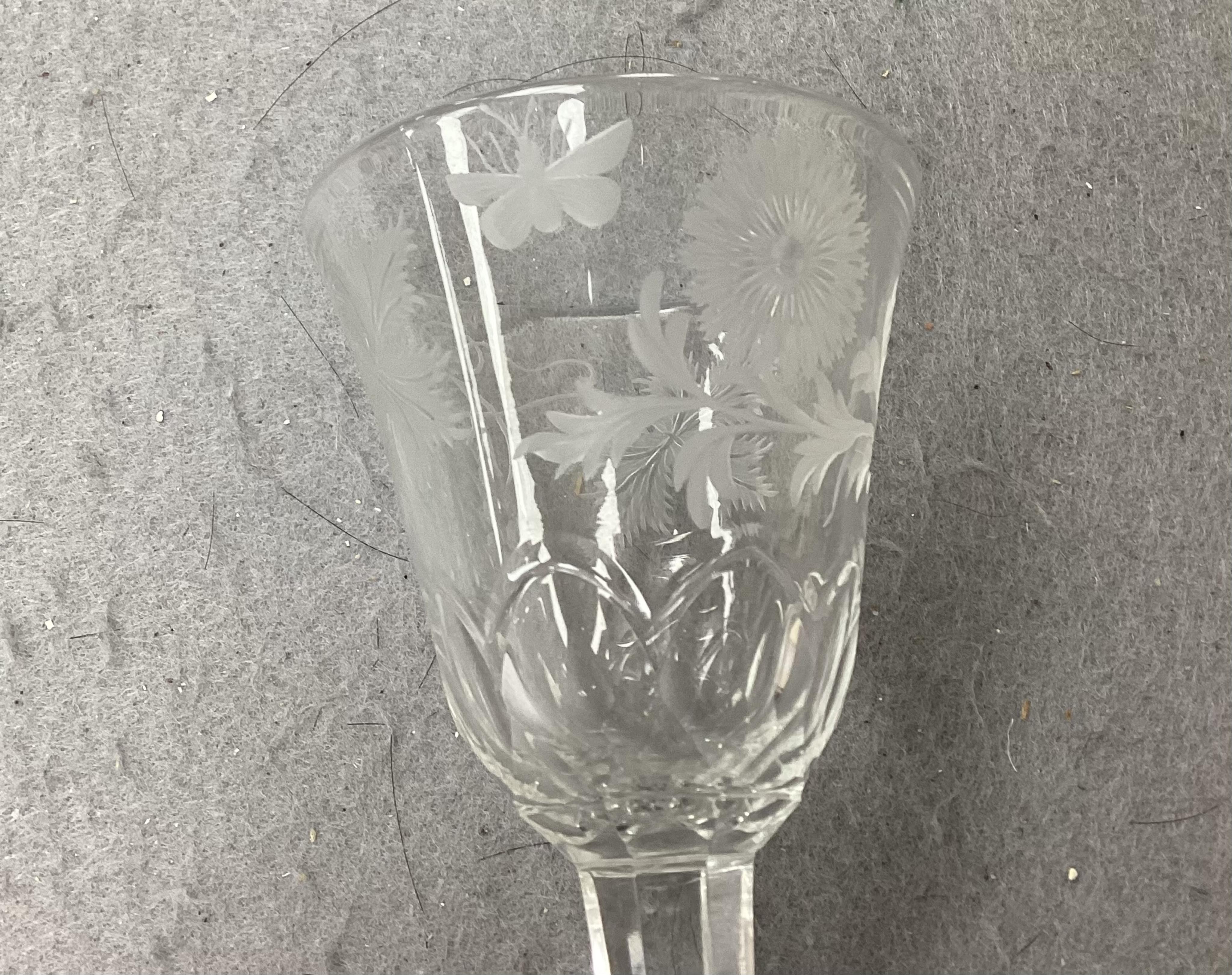 A DSOT stem goblet, circa 1765, with a cup shaped bowl, diamond point engraved ‘J Edden’and a facet stem wine glass, circa 1770, the round funnel bowl engraved with fruiting vines a chrysanthemum and a moth, 15.3cm and 1